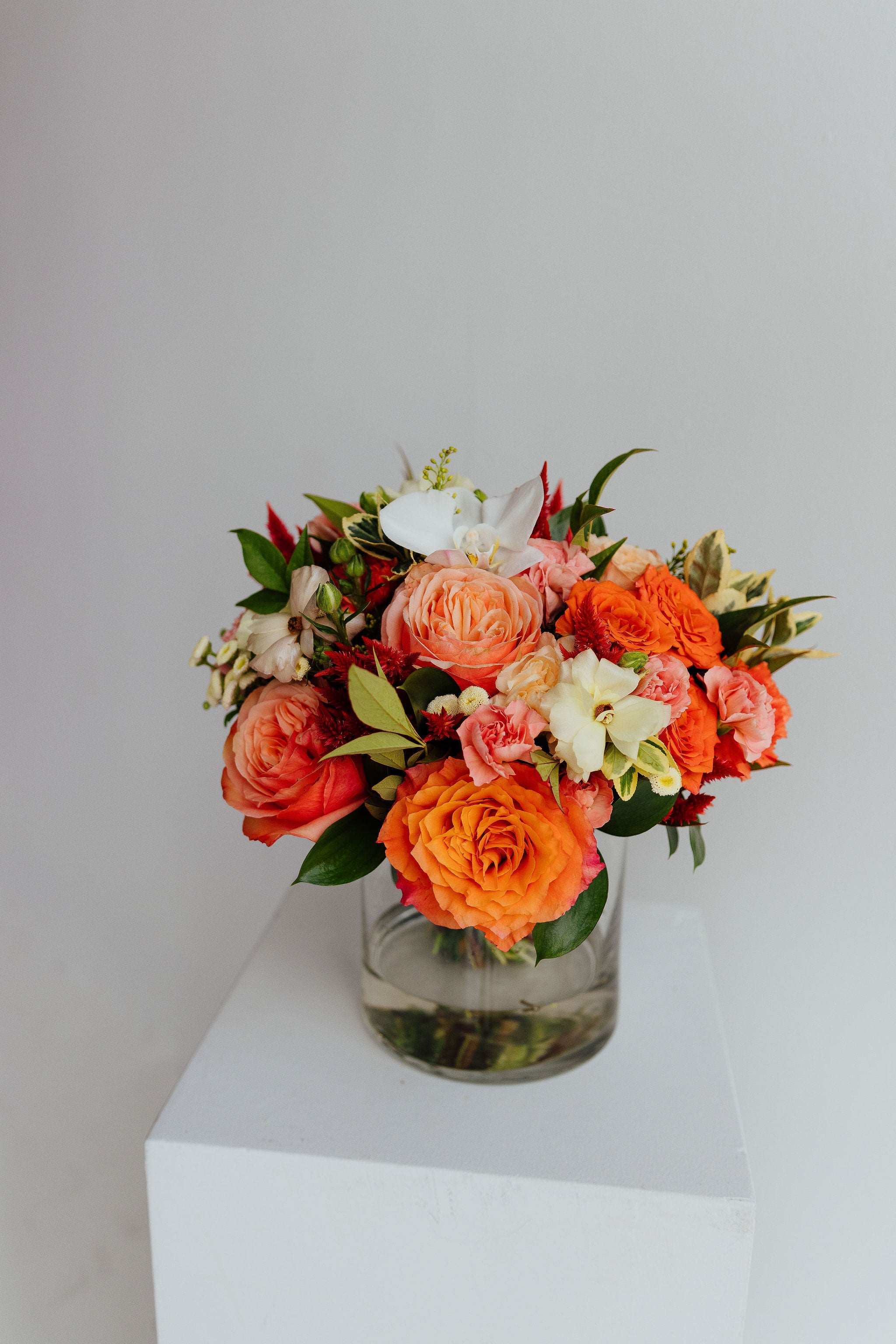 Fall-themed flower arrangement in a glass vase