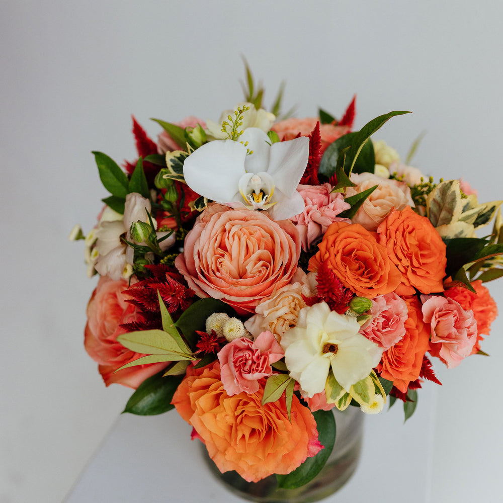 
                      
                        Fall-themed flower arrangement in a glass vase
                      
                    