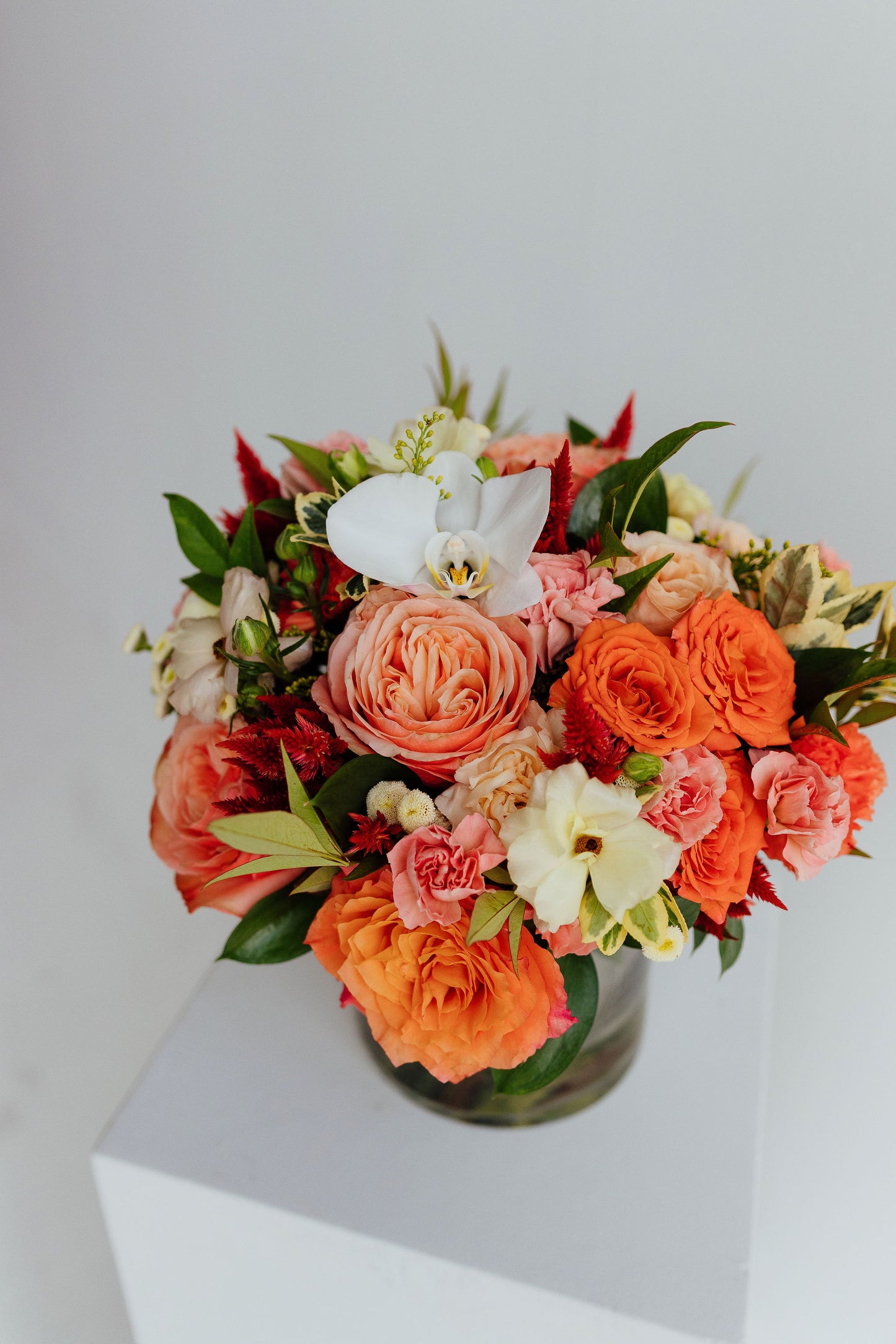 Fall-themed flower arrangement in a glass vase