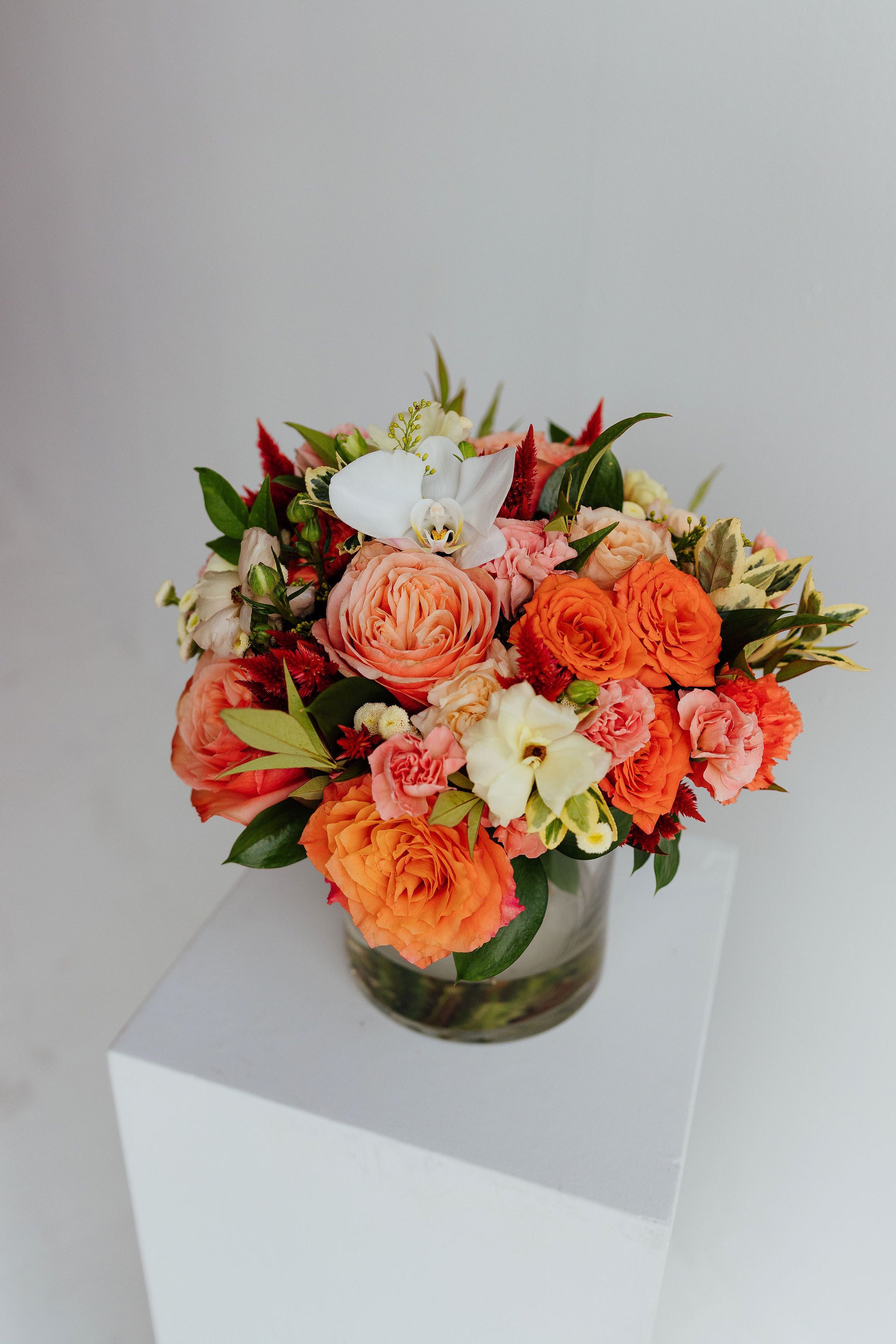 Fall-themed flower arrangement in a glass vase