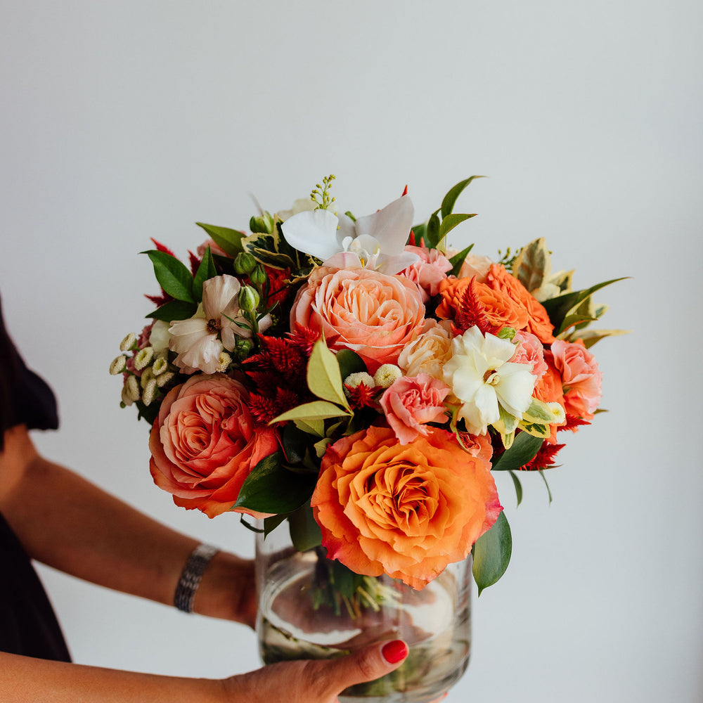 
                      
                        Fall-themed flower arrangement in a glass vase
                      
                    