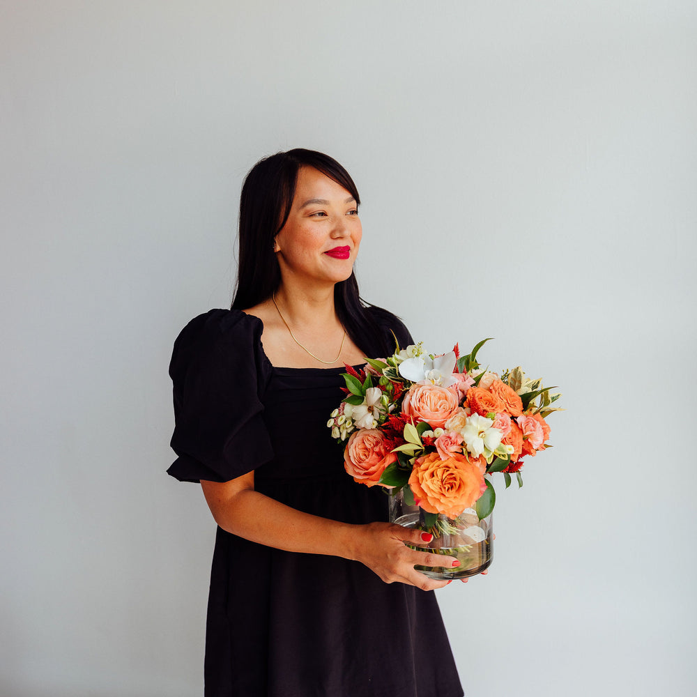 
                      
                        Fall-themed flower arrangement in a glass vase
                      
                    