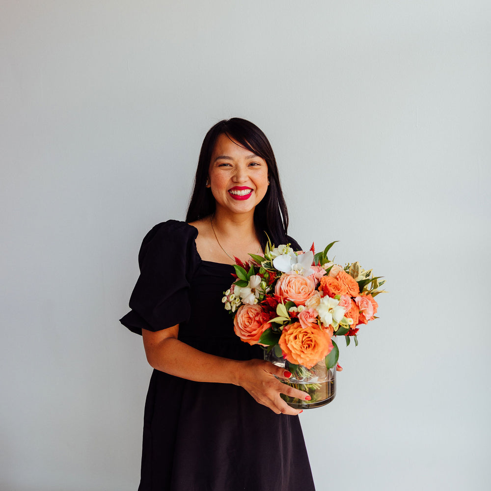 
                      
                        Fall-themed flower arrangement in a glass vase
                      
                    